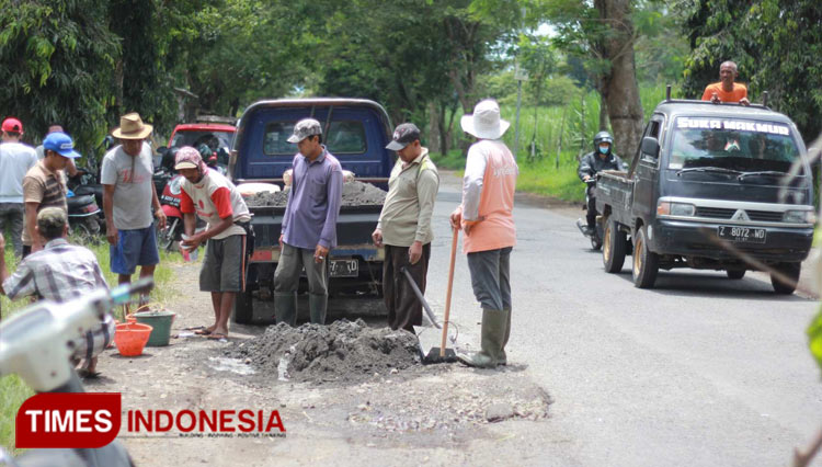 Warga Desa Kuwolu, Malang ketika memperbaiki jalan rusak secara swadaya. (Foto : Binar Gumilang/TIMES Indonesia).