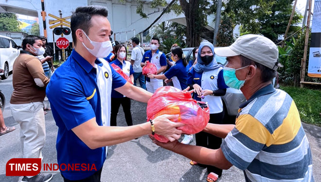 Kepala Cabang Midtou Aryacom Futures Surabaya, Abdi Hery Irwanto membagikan sembako kepada warga tidak mampu di seputaran rel kereta api Gubeng Surabaya, Sabtu (2/4/2022). (Foto: Lely Yuana/TIMES Indonesia)