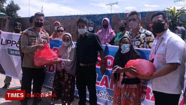 Penyerahan bantuan paket sembako secara simbolis yang dilakukan Ketua BMGK dan Kapolsek Klojen di Kelurahan Jodipan, Kamis (28/4/2022). (FOTO: Rizky Kurniawan Pratama/TIMES Indonesia)