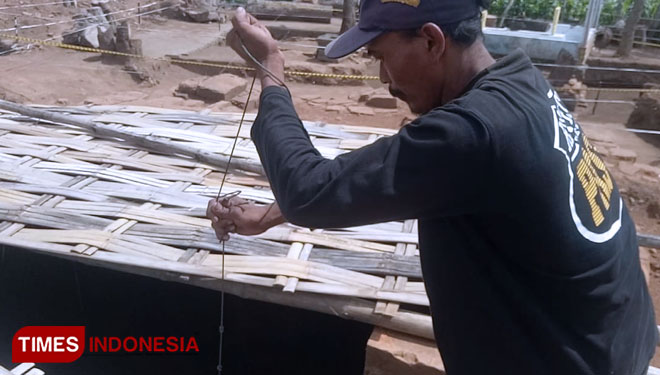 Jayadi, juru kunci Situs Pandegong saat menimba air di situs. (FOTO : Rohmadi/TIMES Indonesia)