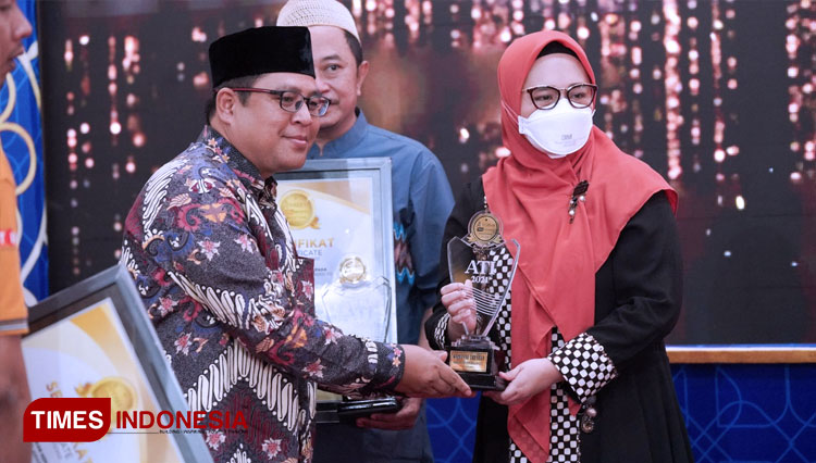 CEO TIMES Indonesia, Khoirul Anwar menyerahkan Anugerah Women of The Year kepada Dr. dr Mirrah Samiyah (FOTO: Taufiq/TIMES Indonesia)
