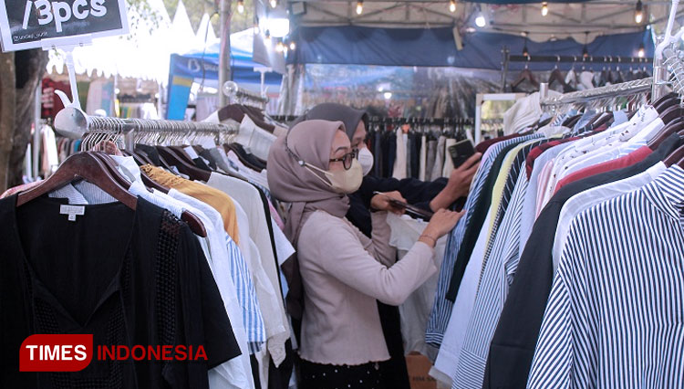 Pengunjung event thrift market di kota Kediri tengah memilih baju di salah satu booth (FOTO: Yobby/TIMES Indonesia)  