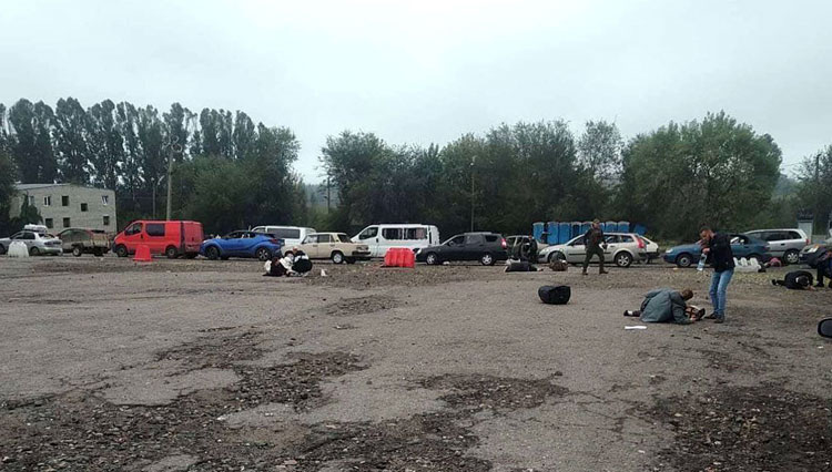 Dua baris mobil yang hancur dengan sejumlah korban bergeletakan di tanah usai dihantam rudal.(FOTO: The Moscow Times)