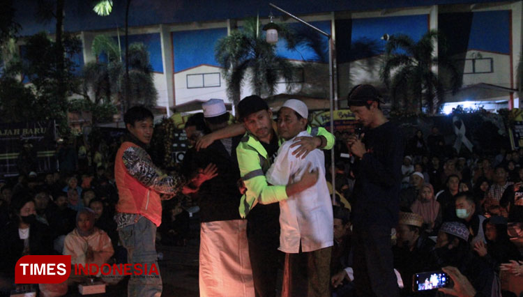 Asisten Manajer Persebaya Surabaya Alex Tualeka memeluk Aremania sesaat setelah doa bersama di Stadion Kanjuruhan. Rabu (5/10/2022). (Foto: Tria Adha/TIMES Indonesia)