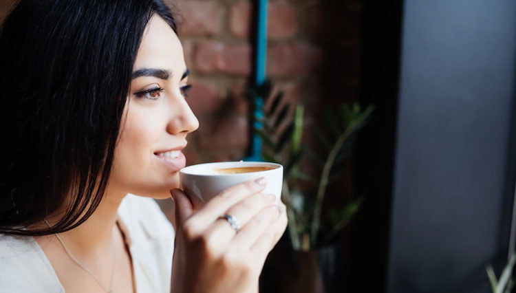 A girl holding a cup of coffee on her hand. (Photo:  diana.grytsku/Freepik)