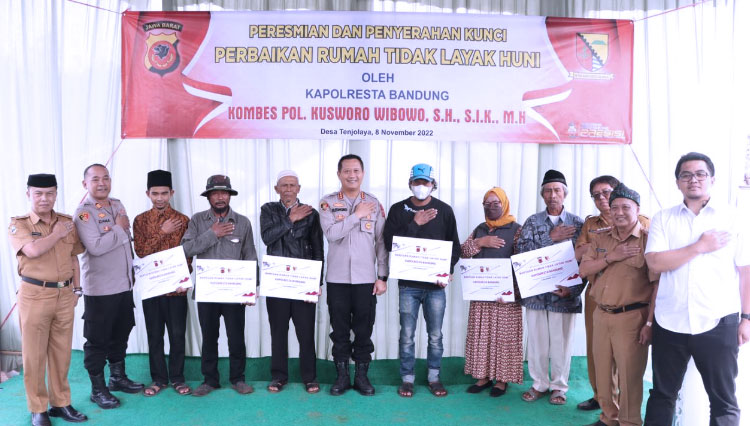 Kapolresta Bandung Kombes Pol Kusworo Wibowo menyerahkan kunci enam unit rumah yang rampung dibedah, di Kampung Berbera, Desa Tenjolaya, Kec Pasirjambu, Selasa (8/11/2022). (Foto: Polresta for TIMES Indonesia)