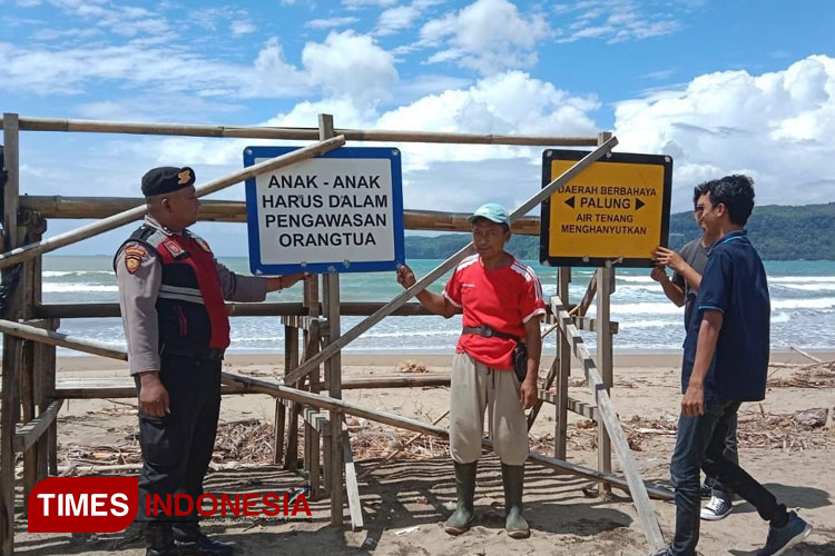 Anggota Sat Samapta Polres Pacitan sedang berpatroli memberikan imbauan kepada pelancong di Pantai Watukarung. (FOTO: Yusuf Arifai/TIMES Indonesia)