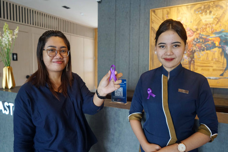 Foto: Resepsionis ASTON Mojokerto Hotel & Conference Center menyambut tamu dengan mengenakan pita ungu, Sabtu (4/2/2023). (Foto: Dok. ASTON Mojokerto for TIMES Indonesia)