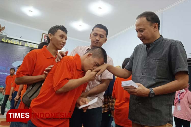 Sekjen Ikarholaz, Syaiful Huda membagikan santunan dari para anggota kepada anak-anak penghuni Liponsos Kalijudan Surabaya, Senin (10/4/2023). (Foto: Lely Yuana/TIMES Indonesia)