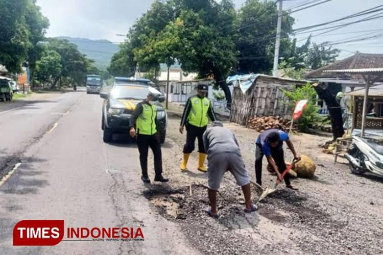 Polisi menambal jalan berlubang di jalur Pantura Besuki, Kabupaten Situbondo bersama masyarakat (FOTO: TIMES Indonesia)