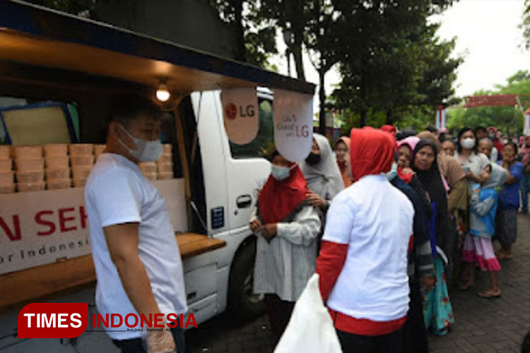 Tim LG membagikan makanan sehat dan suplemen kepada masyarakat di Kawasan TPS Kembang Kuning Surabaya, Kamis (27/4/2023). (Foto : Lely Yuana/TIMES Indonesia)