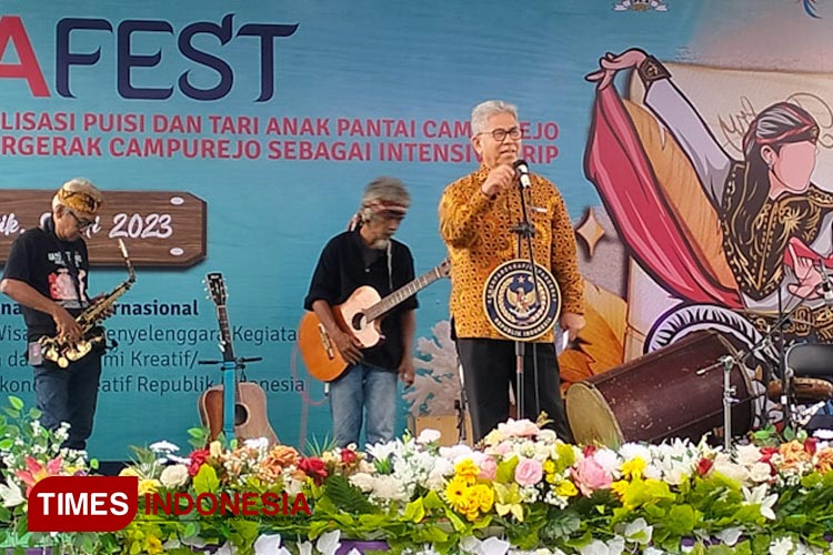 Anggota DPR RI Prof Zainuddin Maliki saat membaca puisi yang diiringi Sanggar Cager di Pantai Desa Campurejo Gresik (FOTO: Akmal/TIMES Indonesia).