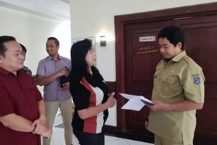 Warga Perumahan Graha Natura saat menyerahkan surat permohonan hearing kepada Komisi C DPRD Kota Surabaya, Senin (25/9/2023). (FOTO: Dok. DPRD Surabaya)