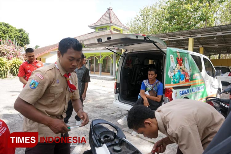 Layanan servis gratis pada motor guru SD dan SMP yang dilakukan oleh siswa teknik SMKN 1 Klabang Bondowoso (FOTO: Moh Bahri/TIMES Indonesia) 