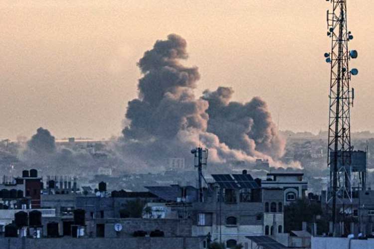 Sebuah foto yang diambil dari Rafah, Gaza, menunjukkan asap mengepul di atas Khan Younis, Gaza, selama pemboman Israel pada 14 Januari. (FOTO: CNN/AFP/Getty Images)