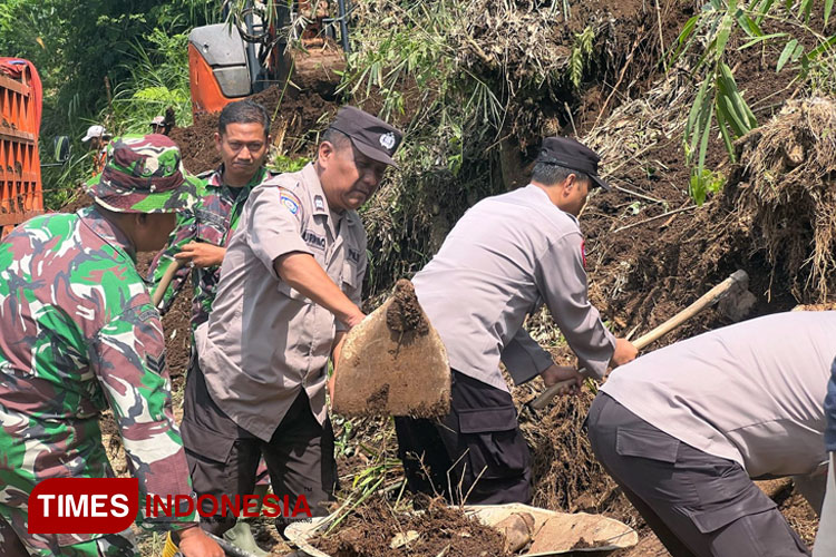 Petugas gabungan Polri dan TNI, bersama relawan dan warga saat evakuasi pembersihan material tanah longsor yang menghalangi jalan desa di Desa Dalisodo, Kecamatan Wagir, Kabupaten Malang, Rabu (28/2/2024). (FOTO: Humas Polres/TIMES Indonesia) 