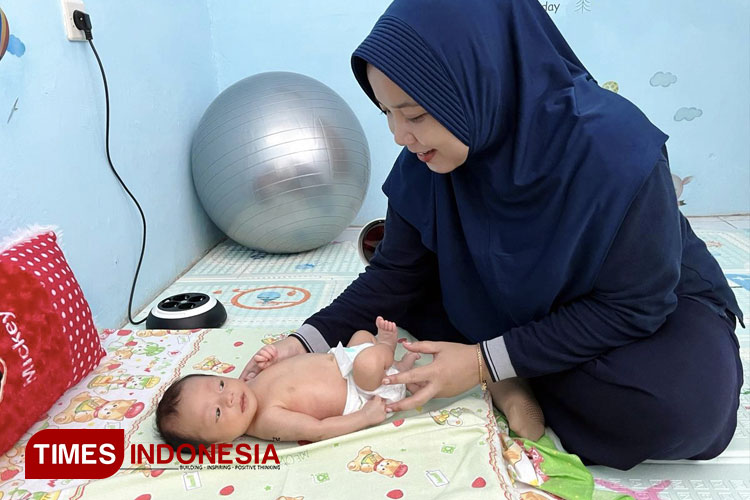 Rosalia Rika Alphy Ariyani, S.Tr. Kes., Ftr, CPHCT saat melakukan pijat bayi. (Foto: Aditya Candra/TIMES Indonesia)