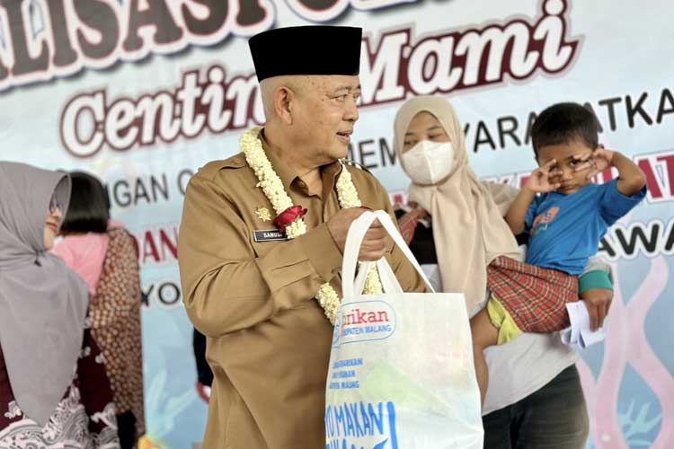Bupati Sanusi, saat menyerahkan paket bantuan produk olahan ikan kepada perempuan dan balitanya, saat Panen Raya Budidaya Ikan Nila dan Sosialisasi Gemarikan Centing Mami, di Wisata Latar Bale, Desa Wonorejo, Lawang, Kabupaten Malang, Senin.