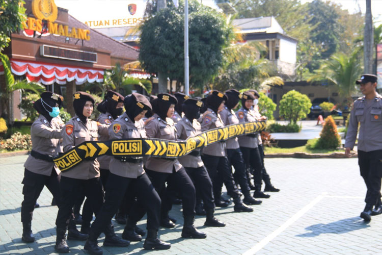 Personel Polres Malang sigap membentuk barisan, lengkap membawa tameng mika dan pentungan, dalam latihan pengendalian massa untuk pengamanan pilkada 2024, di halaman Mapolres Malang, Kamis (18/7/2024). (FOTO: Humas Polres)