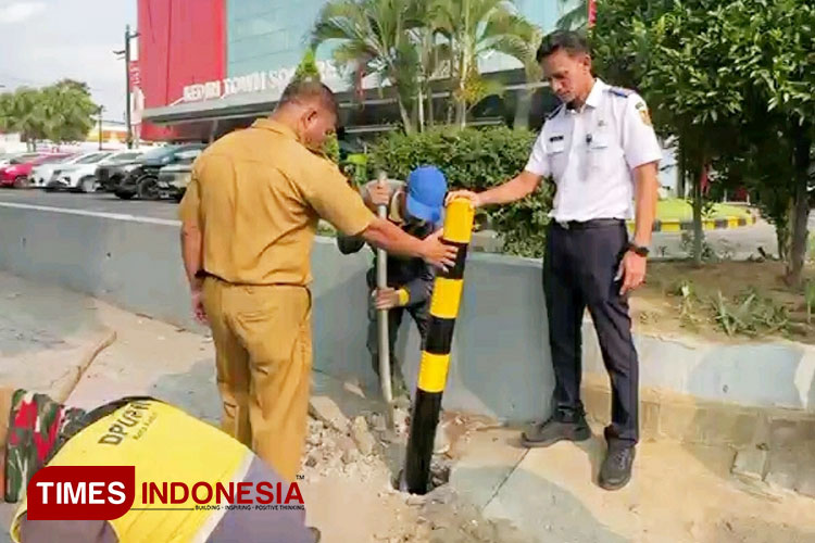Petugas memasang delineator di salah satu ruas trotoar (FOTO: Yobby/TIMES Indonesia)