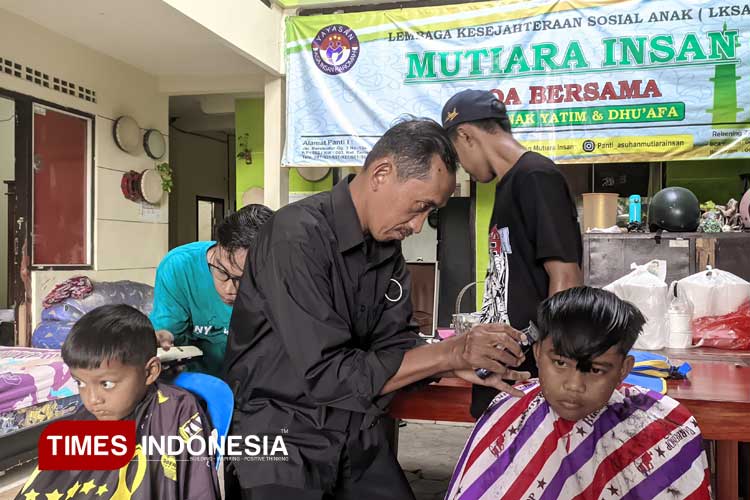 Siswandi, bersama dua anaknya saat menggelar bakti sosial di Panti Asuhan Mutiara Insan, Banyuwangi. (FOTO: Ikromil Aufa/TIMES Indonesia)