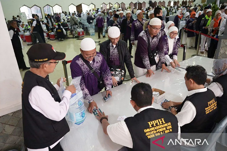 Jamaah haji kloter JKG 63 antre mengambil air zam-zam di Asrama Haji Pondok Gede, Jakarta, Minggu (21/7/2024). (FOTO: ANTARA)