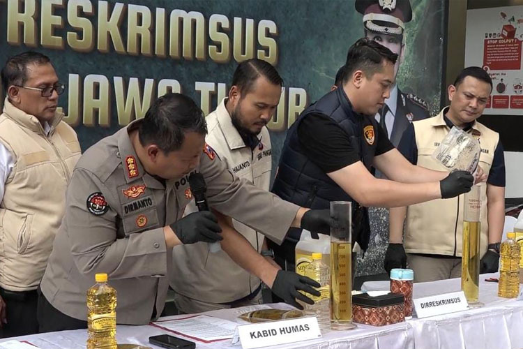 Tim Ditreskrimsus Polda Jatim mengukur minyak kemasan Minyakkita, dan ditemukan ukurannya tidak sesuai dalam kemasan 1 liter, Rabu (12/3/2025). ((FOTO: Dok.Polda Jatim)