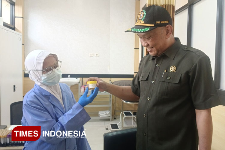 Salah seorang wakil pimpinan DPRD Bondowoso Andi Wijaya saat menyerahkan urine terhadap petugas (FOTO: Moh Bahri/TIMES Indonesia)