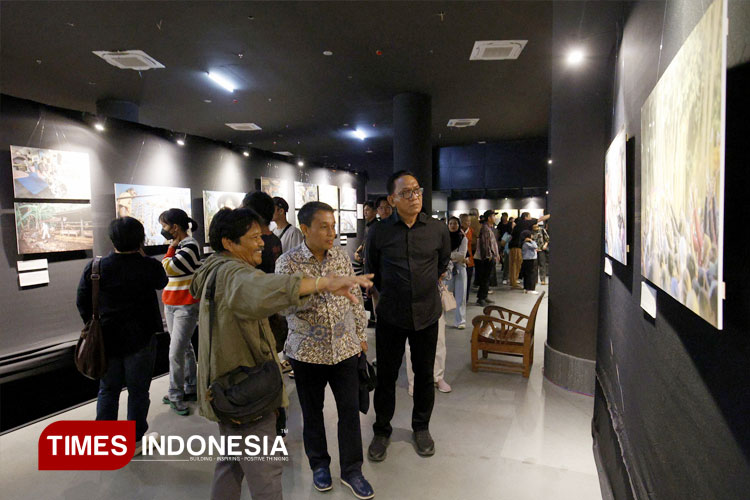 Ketua pameran Dwi Oblo Prasetyo menjelaskan karya yang dipamerkan kepada Kepala Dinas Kominfo DIY, Hari Edi Tri Wahyu Nogroho, dan Wakil Walikota Yogyakarta, Wawan Harmawan di GIK UGM, Kamis, 1/5/2025. (FOTO: Eko Susanto/TIMES Indonesia)