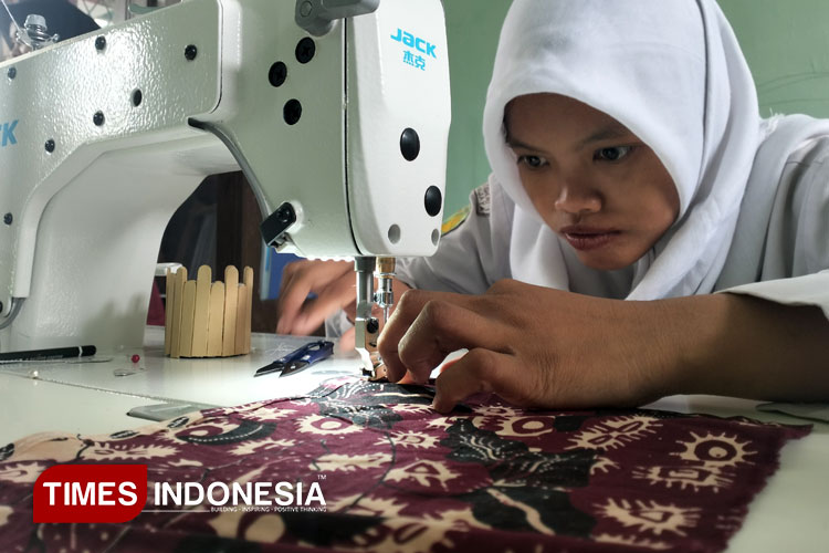 Seorang ABK binaan Papeditas saat menjahit sebuah tote bag di workshop Papeditas, Senin (26/5/2025) (FOTO : Harniwan Obech/TIMES Indonesia)