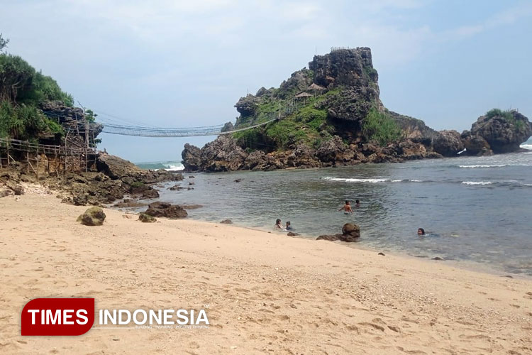 Wisatawan menikmati keindahan Pantai Nglambor di Gunung Kidul, Yogyakarta. (Foto: Hamida Soetadji/TIMES Indonesia)