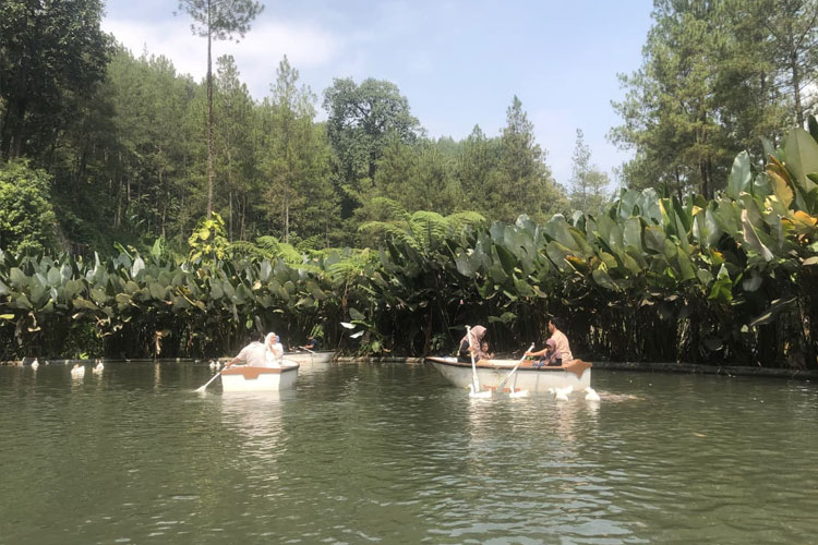 Keluarga menikmati wahana perahu di Taman Kemesraan – salah satu spot foto favorit wisatawan. (Foto: Alfi untuk TIMES Indonesia)