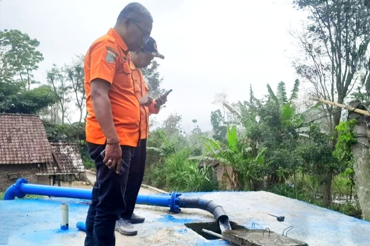 Petugas BPBD Kabupaten Malang saat mengontrol bak penampungan di salah satu wilayah desa rawan kekeringan sebagai antisipasi musim kemarau, kemarin. (Foto: BPBD)
