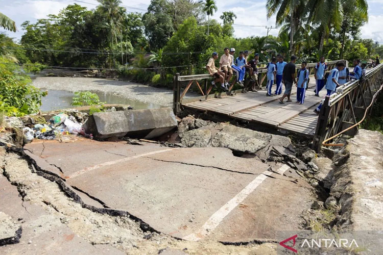 Sejumlah pelajar mengamati Jembatan Siriwini Bawah yang rusak akibat gempa di Kabupaten Nabire, Provinsi Papua Tengah, Jumat (19/9/2025). (ANTARA FOTO/Jack/sgd/nz)