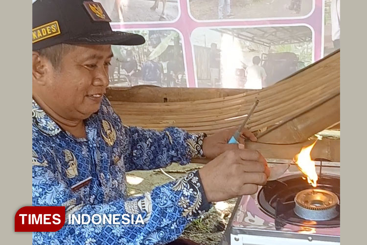 Kades Kujangsari menunjukkan api yang dihasilkan dari Biogas. (Foto: Susi/Times Indonesia)